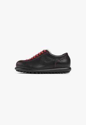Black leather shoe with red laces, rounded toe, and textured sole. Features contrasting stitching and a low-profile design.