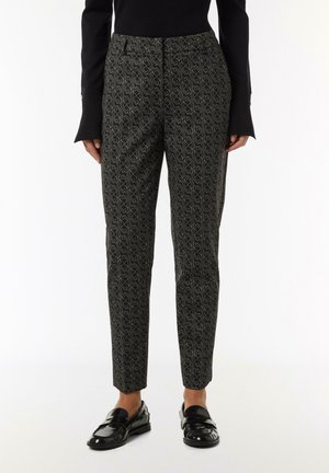 Black and patterned trousers featuring a geometric design in olive green, tailored fit, smooth fabric, and ankle-length cut.
