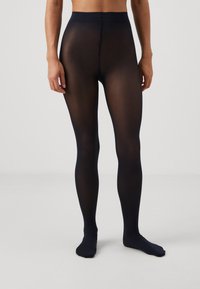 Collants opaques noirs avec une texture lisse, couverture entière, et une ceinture douce et large. Aucune motif ni coutures visibles.