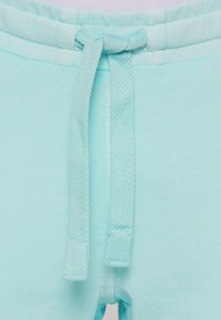 Licht turquoise sweatpants met een trekkoord, voorzien van een gestructureerd, geweven patroon en een gladde, zachte stofafwerking.