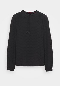 Blusa nera a maniche lunghe con collo rotondo e dettaglio con lacci, caratterizzata da un motivo a pois testurizzati e polsini elasticizzati. Tessuto morbido e leggero.