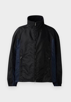 Black and navy windbreaker jacket featuring a high collar, zippered front, and side pockets with elastic cuffs and a smooth texture.