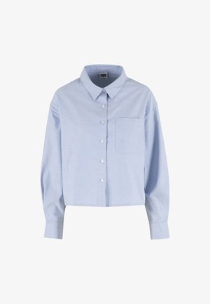 Svijetloplava košulja s dugim rukavima, džepom na lijevoj strani prsa i šiljastim ovratnikom, skraćena do struka.