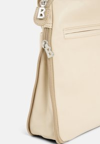 Beige synthetic bag with a smooth texture, featuring silver B-shaped zipper pulls and a zippered pocket on the back.
