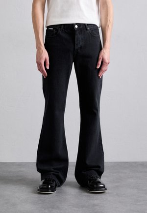 EYTYS CYRUS RAVEN - Flared jeans - black
