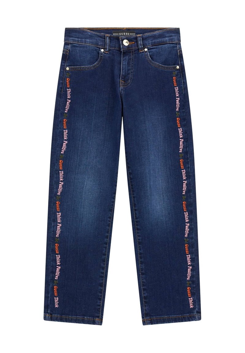 Dark blue denim jeans with a straight-leg design. Features embroidered text along the outer seams with "GUESS" and "Think Positive."