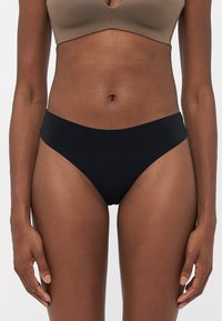 Black bikini underwear with a smooth texture, high-cut design, and wide side bands. Suitable for everyday wear and versatile styling.
