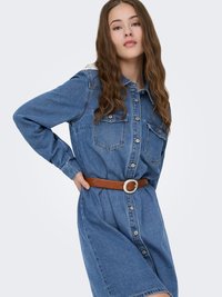 Denim shirt dress in light blue with button closure, two chest pockets, and a brown belt with a round silver buckle for accent.