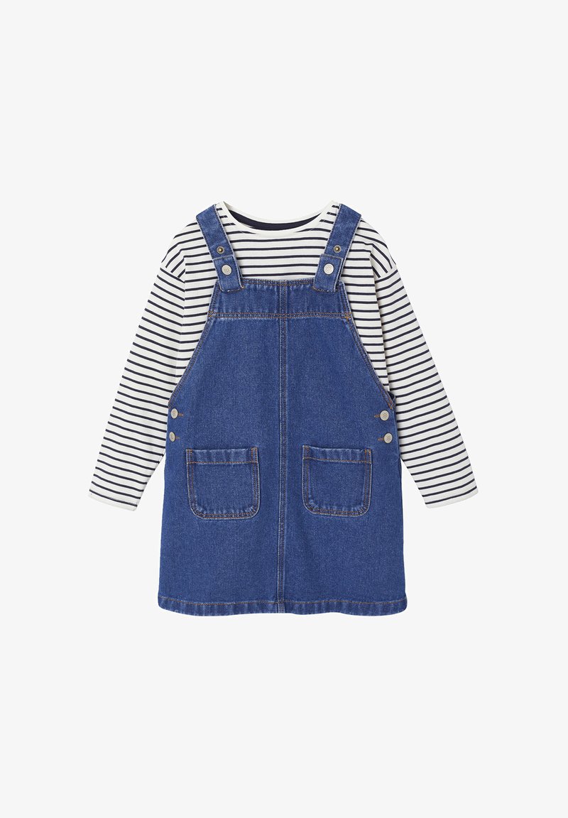 Dunkelblaures Jeans-Overall-Kleid mit zwei Fronttaschen, verstellbaren Trägern und einem weißen gestreiften Langarmshirt, das darunter getragen wird.