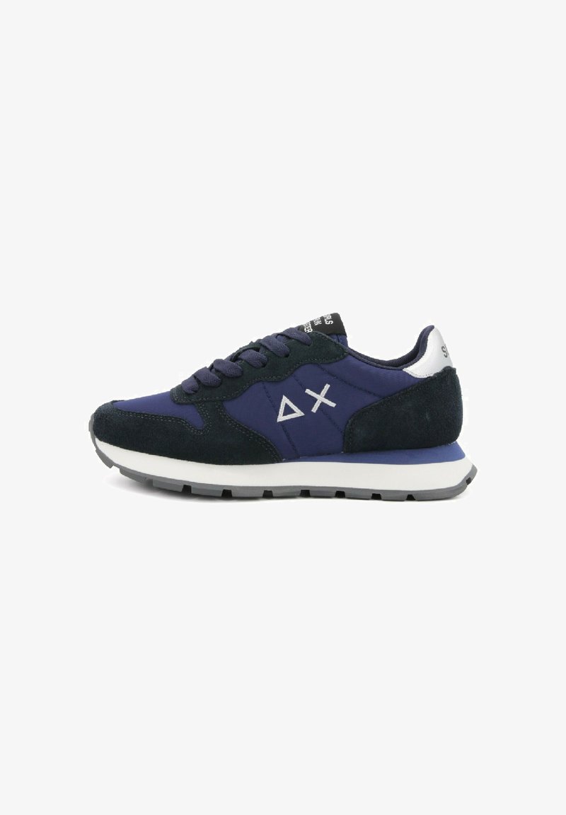 Navy blue and black sneaker with white sole, suede accents, laces, and white triangle and X logo on side.