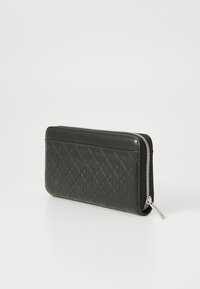 Black leather wallet with diamond pattern, zip closure, and silver hardware. Smooth texture with an embossed design on one side.