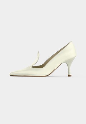 White leather mid-heel pump with pointed toe and a slim curved heel, photographed against a plain light gray background.