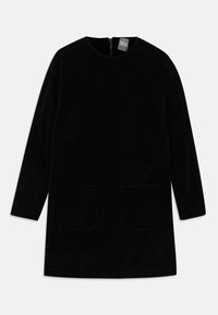 Musta corduroy-mekko, jossa on pitkät hihat, korkea kaula-aukko ja kaksi etutaskua. Mekossa on takana vetoketju ja teksturoitu kangas.