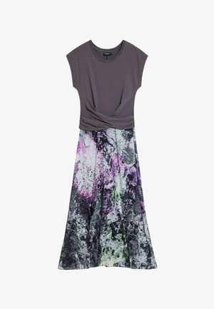 Grå top med korte ærmer og en tvistet detalje ved taljen, som flyder ned i en farverig abstrakt blomsterprintnederdel i lilla, sort og grøn.