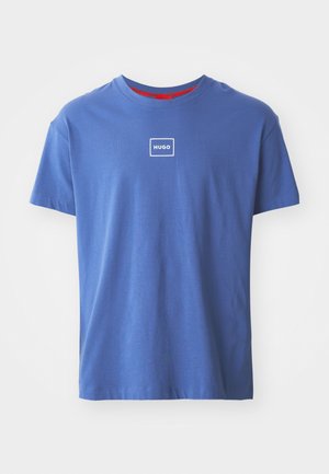 Blue cotton t-shirt featuring a round neckline and short sleeves. It has a white rectangular logo with "HUGO" on the front.