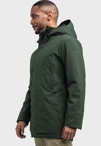 Grüne Außenjacke mit Kapuze, aus strukturiertem Stoff. Verfügt über Reißverschlusstaschen und verstellbare Bündchen für eine verbesserte Passform.