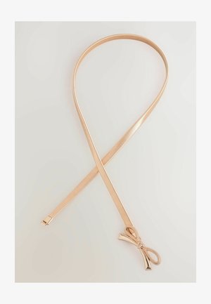 Kuldtooni metallist juukseriba, mille pind on sile ja läikiv, ning mille ühel küljel on pael. Sirge, paindlik disain ja sale profiil.