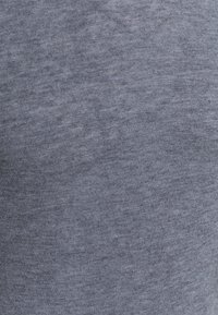 Cotton-blend fabric in a heathered dark blue shade, featuring a soft texture and a subtle knit pattern throughout.