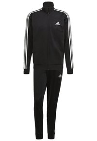 Survêtement Adidas noir avec des bandes blanches sur les manches et les jambes du pantalon, veste zippée, et logo Adidas sur la poitrine et la cuisse.
