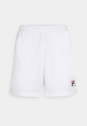 White athletic shorts with an elastic waistband, made of a smooth fabric. Features a small multicolored Fila logo on the left hem.