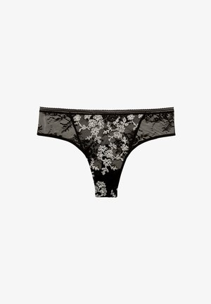 Black lace thong with white floral embroidery and scalloped waistband detail, displayed on a white background.