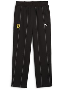 Fekete sportnadrág fehér csíkokkal, rugalmas derékkal, oldalsó zsebekkel, egy sárga Ferrari logóval és egy fehér Puma logóval az oldalon.