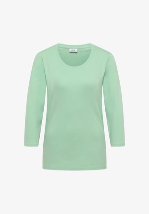 Lichtgroen dames shirt met lange mouwen, ronde halslijn en label "CECIL" bij de kraag.