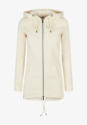 Hoodie zippé couleur crème avec capuche à cordon de serrage, poches avant et poignets côtelés. Fabriqué à partir d'un tissu doux et texturé.