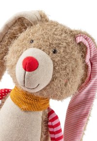 Stuffed bunny toy with fluffy light brown fur, red nose, and black eyes. Features striped ears in pink and white, with a yellow neck collar.