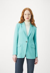 Blazer turchese con un design classico, due tasche frontali, chiusura a un bottone e una texture liscia con una vestibilità strutturata.