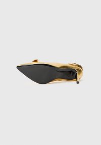 Gold satin stiletto heel with a pointed toe and black rubber sole. Features a decorative accent above the toe for added detail.