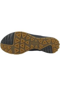 Semelle de chaussure en caoutchouc noir avec un motif texturé de crampons triangulaires pour l'adhérence et un pourtour solide de couleur beige. Comprend des rainures pour la flexibilité.