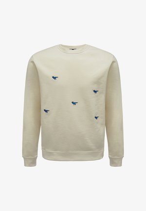 Crème sweatshirt met blauwe geborduurde dinosaurusontwerpen. Klassieke ronde hals, ribgebreide boorden en onderzoom. Zachte stof met een gladde textuur.