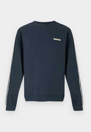 Námornícka tmavomodrá mikina s dlhými rukávmi, béžovými pruhmi s logom na rukávoch a malou nášivkou s logom na hrudi.