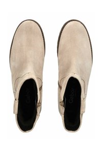 Botines de ante en beige claro con punta redondeada. Cuentan con un cierre lateral y acentos de costura a lo largo de los bordes.