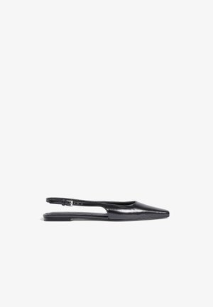 Black leather slingback flats with a pointed toe, cutout sides, and a single adjustable strap at the heel. Smooth texture and minimal design.