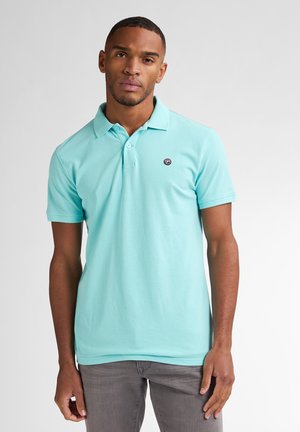 Camisa polo color turquesa hecha de algodón, con cuello, mangas cortas y un pequeño logo en el pecho. Textura suave, ajuste casual.