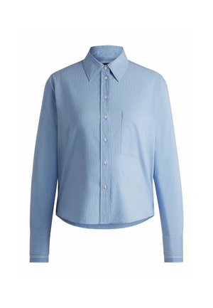 Camicia button-up azzurro chiaro realizzata in tessuto testurizzato, con colletto, maniche lunghe e taschino sul petto. Accentuata da polsini a righe.