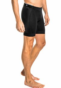 Schwarze sportive Shorts aus einem strukturierten, atmungsaktiven Material, mit einem breiten Bund und einem körperbetonten Design, das bis zur Mitte des Oberschenkels reicht.