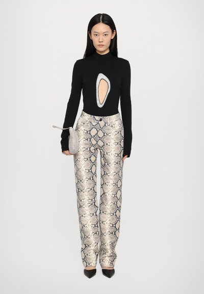 Black long-sleeve bodysuit with a large cutout, paired with metallic, snake-print wide-leg trousers. Features a small silver clutch and black heels.