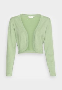 Vaaleanvihreä, lyhyt neuletakki, valmistettu pehmeästä, teksturoidusta kankaasta. Siinä on syvä V-pääntie ja pitkät hihat rentolla istuvuudella.