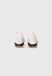 White soccer cleats with a textured finish, black outsole, and orange studs. Features a colorful design in blue and pink on the sides.