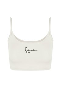 White cropped tank top with adjustable spaghetti straps and a textured appearance. It features black embroidered text on the front.