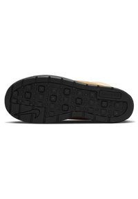 Nike sneaker sole, black rubber with square and rectangular tread patterns, featuring a curved edge and embossed logo detail.