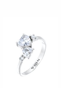 Bague en argent ornée de deux pierres transparentes en forme de cœur et de deux petites pierres rondes en accent. L'intérieur de la bande est gravé "925 Ag."