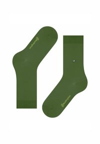 Dwie zielone skarpetki wyeksponowane obok siebie, z logo po bokach i kontrastowymi wzorami na mankiecie i palcach.