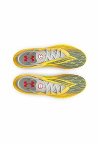 Scarpe da ginnastica gialle e grigie con una parte superiore testurizzata, dotate di lacci grigi e di un logo rosso sulla linguetta. Design slanciato per le performance.