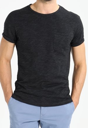 Black short-sleeve T-shirt with a crew neck, featuring a small chest pocket and a textured fabric. Slightly fitted design.