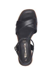 Black leather sandal with crisscross straps and ankle buckle. Square toe design and textured cork look on the sole. Size 37.