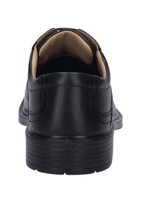 Musta nahkakenkä, jossa on sileä pinta, pyöreä kärki ja teksturoitu kumipohja. Sisäosa on beige kangasta mukavuutta varten.